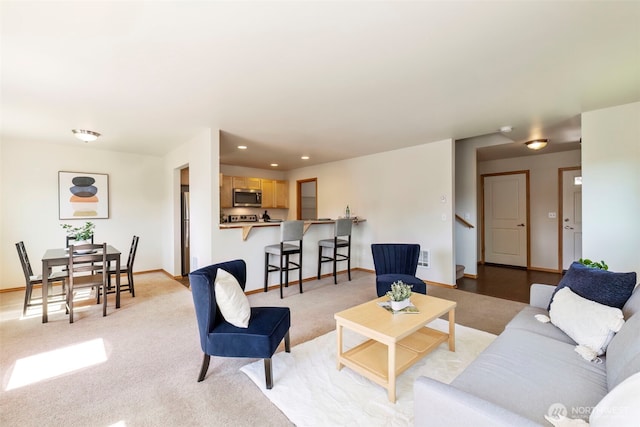 382 NE Ohenry Ct, Poulsbo, WA 98370 - living room featuring baseboards, stairway, light colored carpet, and recessed lighting