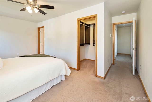 382 NE Ohenry Ct, Poulsbo, WA 98370 - bedroom with a ceiling fan, a closet, a spacious closet, light colored carpet, and baseboards