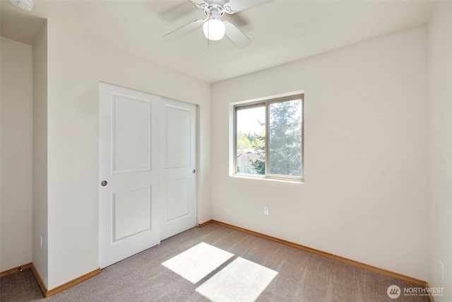 382 NE Ohenry Ct, Poulsbo, WA 98370 - unfurnished bedroom with light carpet, baseboards, and ceiling fan