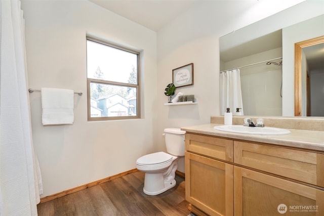 382 NE Ohenry Ct, Poulsbo, WA 98370 - bathroom with baseboards, wood finished floors, vanity, and toilet