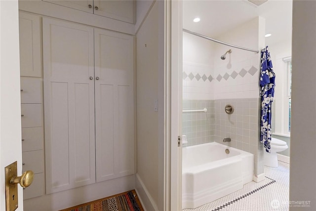 bathroom with tile patterned flooring, shower / bath combo with shower curtain, toilet, and baseboards