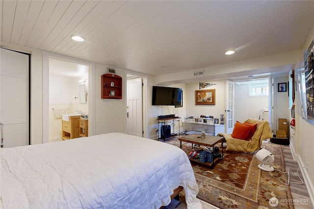 bedroom with wood finished floors, visible vents, and recessed lighting