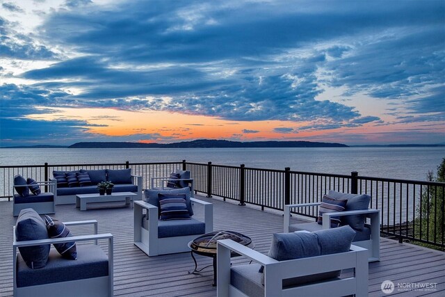 8001 Talbot Rd, Edmonds, WA 98026 - deck at dusk featuring an outdoor living space and a water view