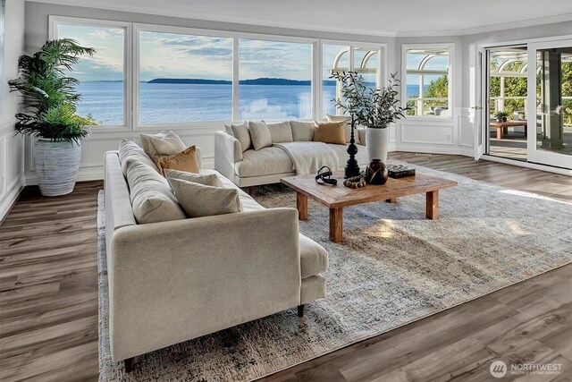 8001 Talbot Rd, Edmonds, WA 98026 - living area with a decorative wall, wood finished floors, ornamental molding, and a wainscoted wall