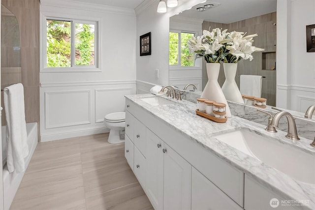 8001 Talbot Rd, Edmonds, WA 98026 - bathroom with a decorative wall, double vanity, ornamental molding, and shower / washtub combination