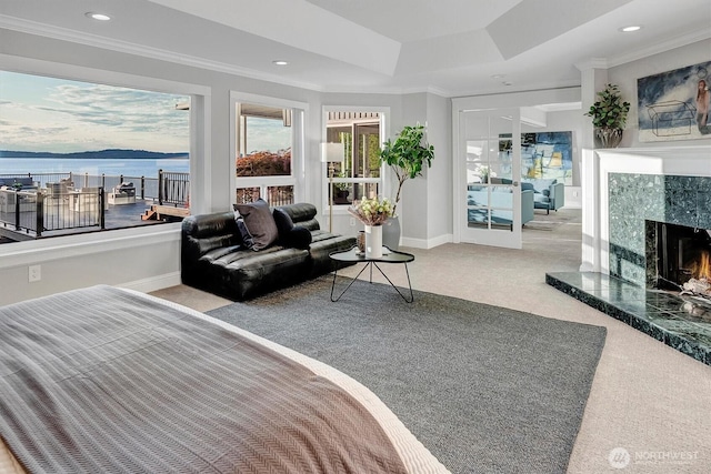 8001 Talbot Rd, Edmonds, WA 98026 - carpeted bedroom featuring ornamental molding, a fireplace, a water view, recessed lighting, and a raised ceiling