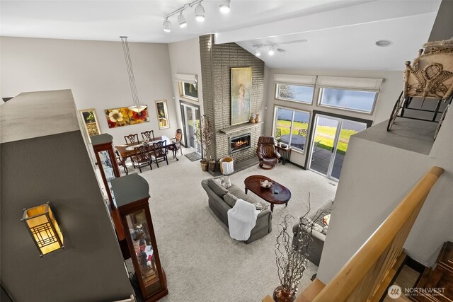 7340 Steilacoom Blvd SW, Lakewood, WA 98499 - living area with a fireplace, ceiling fan, high vaulted ceiling, track lighting, and carpet floors