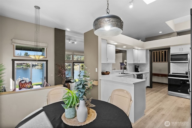 7340 Steilacoom Blvd SW, Lakewood, WA 98499 - dining space with recessed lighting, a skylight, and light wood-type flooring