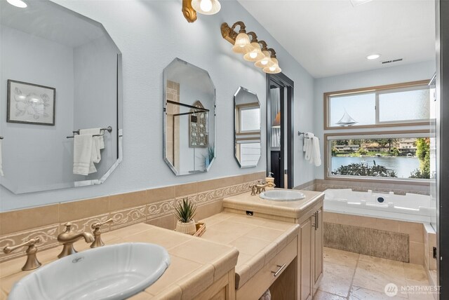 7340 Steilacoom Blvd SW, Lakewood, WA 98499 - bathroom with double vanity, visible vents, a bath, and a sink