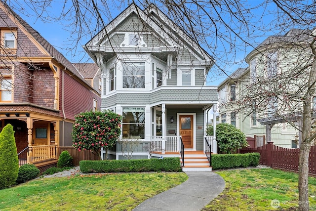511 N E St, Tacoma, WA 98403 - victorian-style house featuring a front lawn, covered porch, and fence