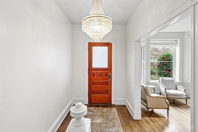 511 N E St, Tacoma, WA 98403 - foyer featuring a chandelier, baseboards, and wood finished floors