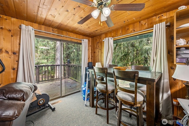 100 N Duckabush Dr W, Hoodsport, WA 98548 - dining space featuring carpet flooring, visible vents, wood ceiling, and wooden walls