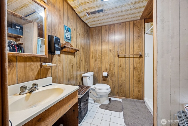 100 N Duckabush Dr W, Hoodsport, WA 98548 - bathroom featuring wood walls, toilet, tile patterned flooring, and vanity