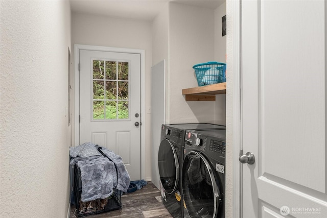 washroom with wood finished floors, washing machine and dryer, and laundry area