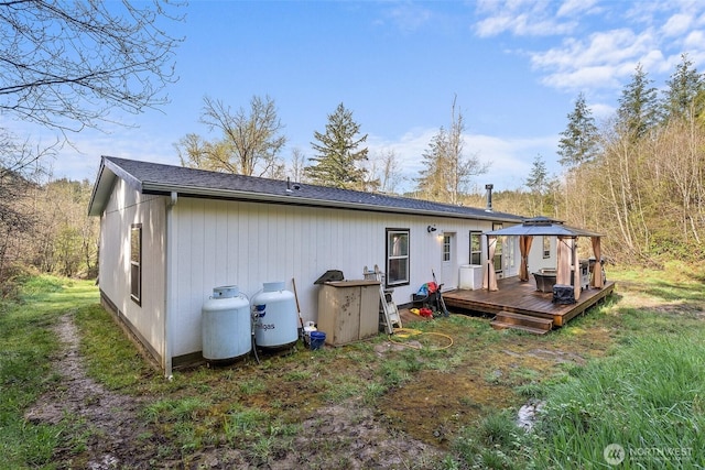 back of house with a gazebo and a deck