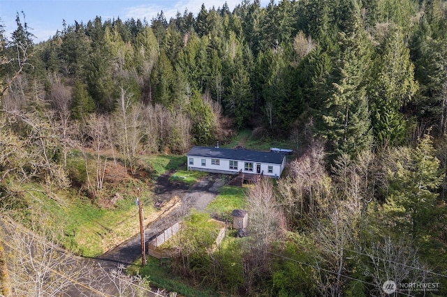 drone / aerial view featuring a forest view