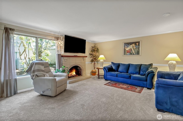 carpeted living room with crown molding, a fireplace, and baseboards