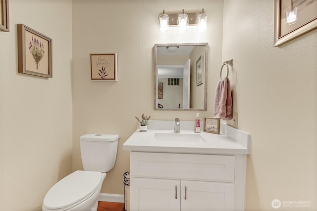 bathroom with toilet and vanity