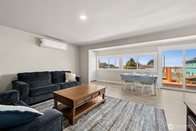 34 4th St S, Pacific Beach, WA 98571 - living room featuring a wall mounted AC, wood finished floors, baseboards, and recessed lighting
