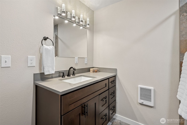 34 4th St S, Pacific Beach, WA 98571 - bathroom featuring vanity, baseboards, and heating unit