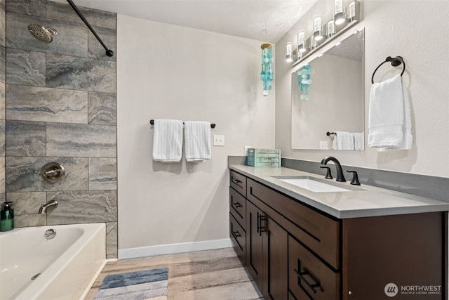 34 4th St S, Pacific Beach, WA 98571 - bathroom featuring shower / bath combination, vanity, baseboards, and wood finished floors