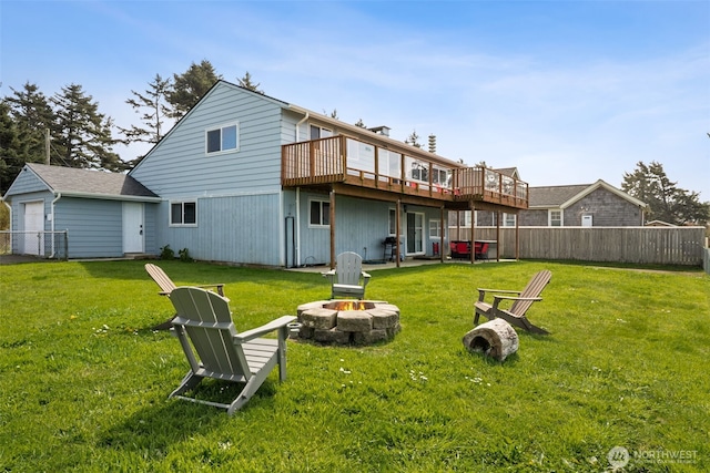 34 4th St S, Pacific Beach, WA 98571 - back of house featuring a yard, a wooden deck, fence, and an outdoor fire pit