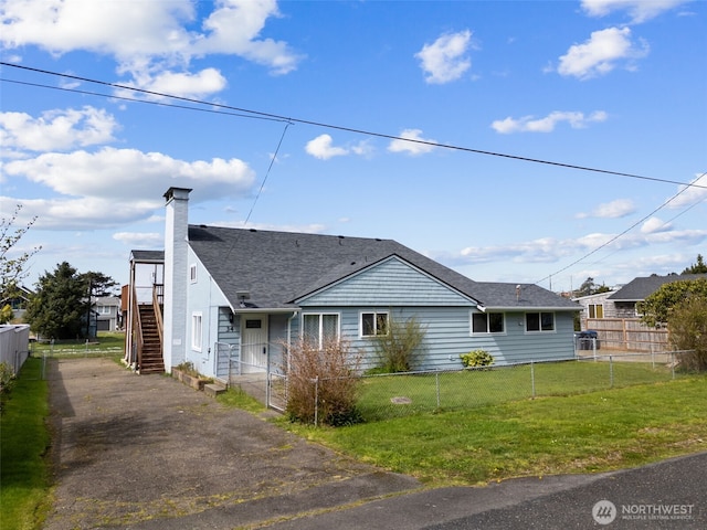 34 4th St S, Pacific Beach, WA 98571 - view of front of home featuring a shingled roof, a chimney, a fenced front yard, and a front yard