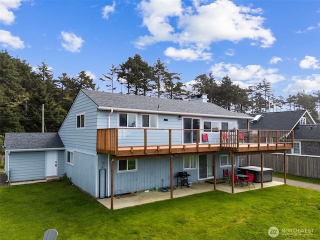 34 4th St S, Pacific Beach, WA 98571 - back of house with a lawn, a patio, a chimney, and a hot tub