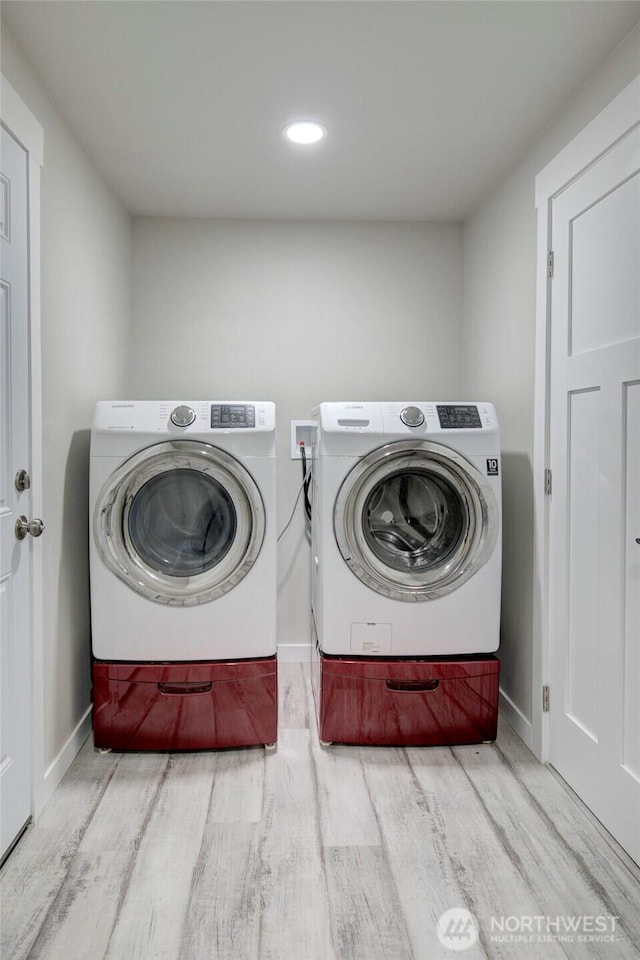 34 4th St S, Pacific Beach, WA 98571 - clothes washing area with separate washer and dryer, laundry area, baseboards, and wood finished floors