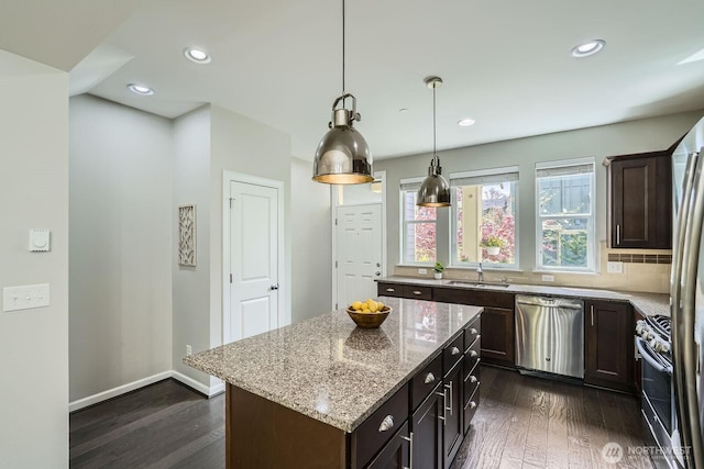 2546 NE Mulberry Walk, Issaquah, WA 98029 - kitchen with dark wood finished floors, light stone counters, stainless steel appliances, a sink, and dark brown cabinetry