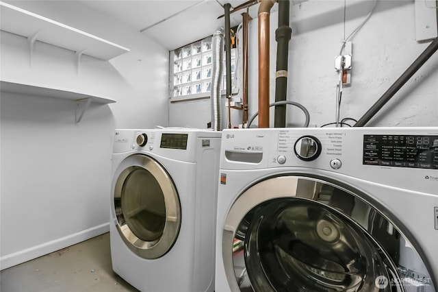 washroom with washer and dryer and baseboards