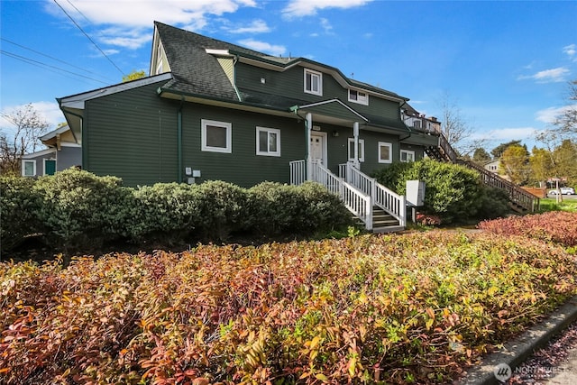 view of front of house with roof with shingles