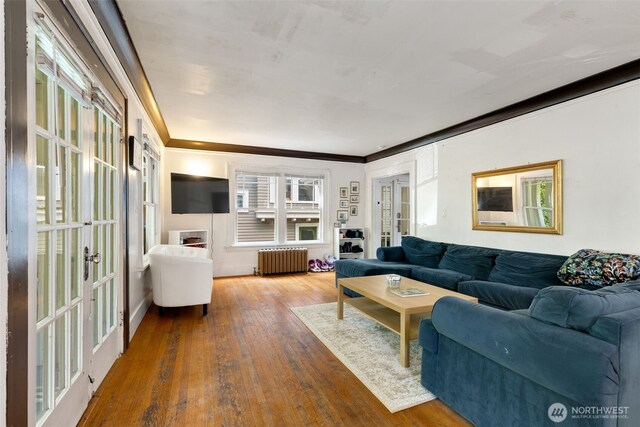 5019 17th Ave NE, Seattle, WA 98105 - living room featuring radiator heating unit, french doors, wood finished floors, and crown molding