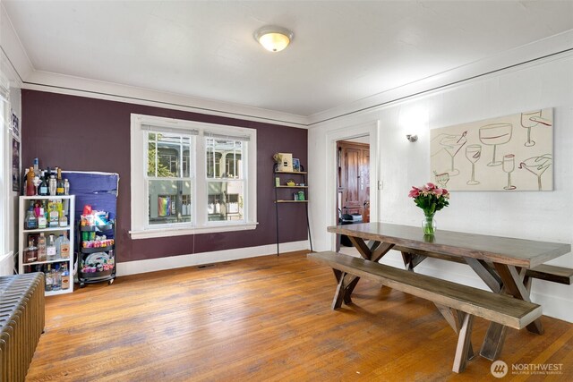 5019 17th Ave NE, Seattle, WA 98105 - dining space with crown molding, wood finished floors, radiator heating unit, and baseboards