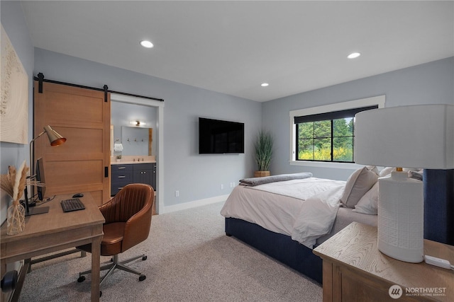 bedroom featuring carpet floors, ensuite bathroom, recessed lighting, and a barn door