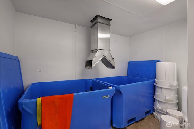 bedroom with attic access and concrete flooring