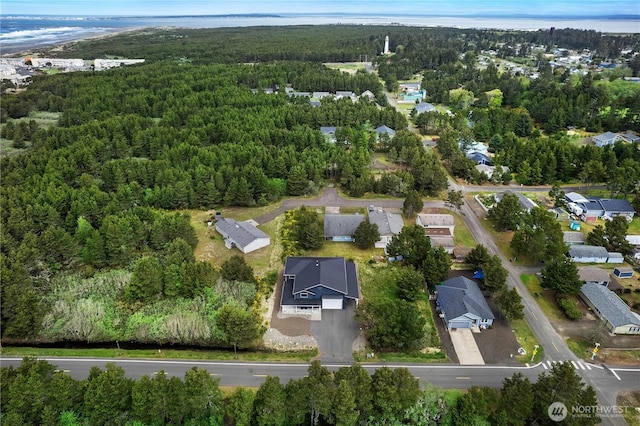 birds eye view of property featuring a residential view and a wooded view
