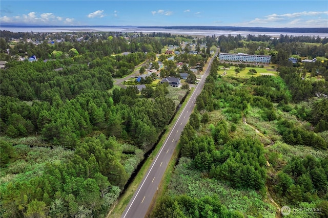 drone / aerial view featuring a forest view