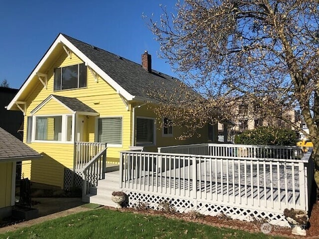 back of house featuring a chimney