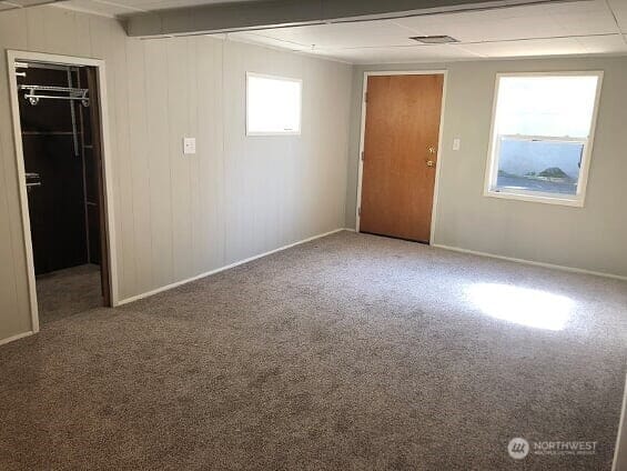 spare room with carpet and baseboards