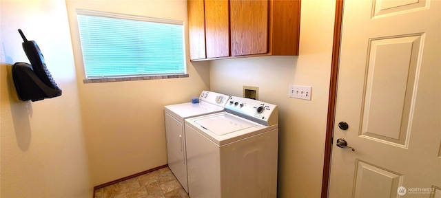 clothes washing area featuring cabinet space, baseboards, and washer and dryer