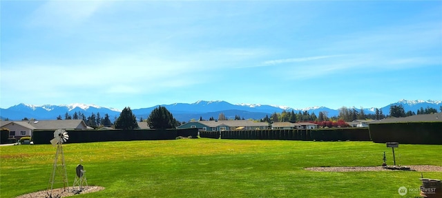 view of property's community with fence and a mountain view