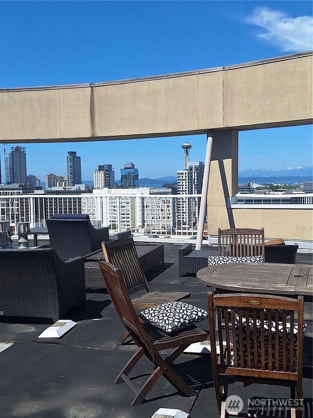 530 Melrose Ave E Unit 705, Seattle, WA 98102 - view of patio / terrace with a view of city and outdoor dining area