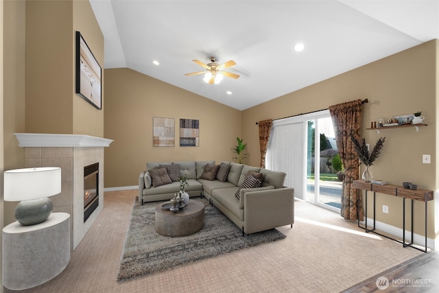 8148 Quinault Rd, Blaine, WA 98230 - living area featuring a tile fireplace, baseboards, a ceiling fan, and vaulted ceiling