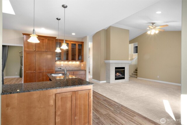 8148 Quinault Rd, Blaine, WA 98230 - kitchen with baseboards, a sink, light wood-style floors, brown cabinets, and backsplash