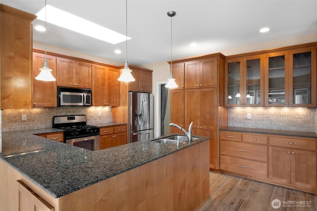 8148 Quinault Rd, Blaine, WA 98230 - kitchen featuring a sink, brown cabinets, decorative backsplash, and stainless steel appliances