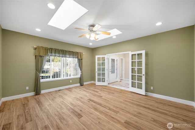 8148 Quinault Rd, Blaine, WA 98230 - unfurnished room featuring a skylight, french doors, wood finished floors, and baseboards
