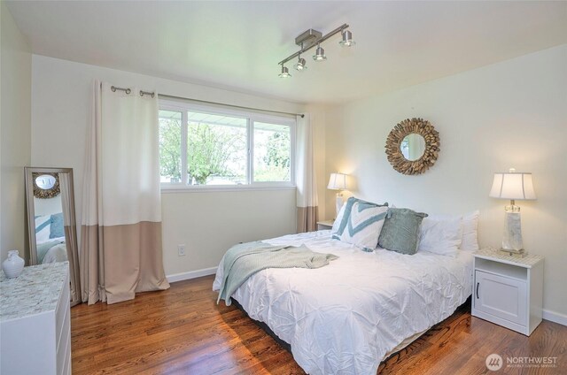 22332 10th Ave S, Des Moines, WA 98198 - bedroom featuring wood finished floors, track lighting, and baseboards
