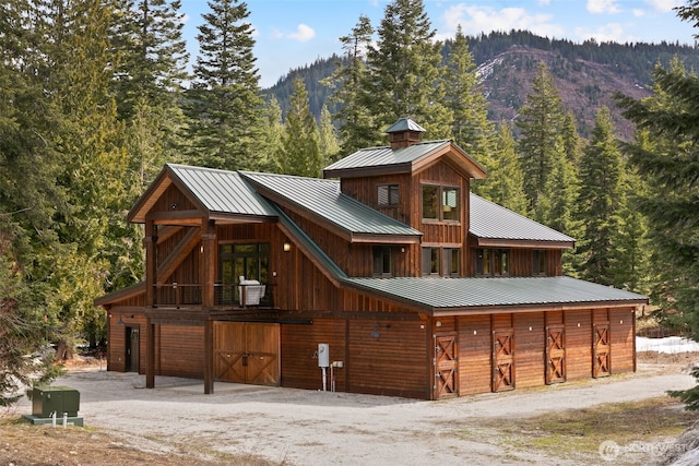 17650 Roaring Creek Rd, Leavenworth, WA 98826 - exterior space featuring a mountain view, a detached garage, dirt driveway, a view of trees, and an outdoor structure