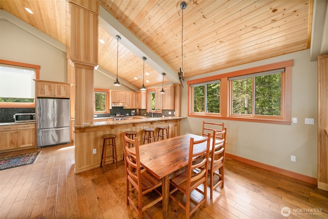 17650 Roaring Creek Rd, Leavenworth, WA 98826 - dining area featuring light wood-style floors, wooden ceiling, a toaster, and lofted ceiling with beams